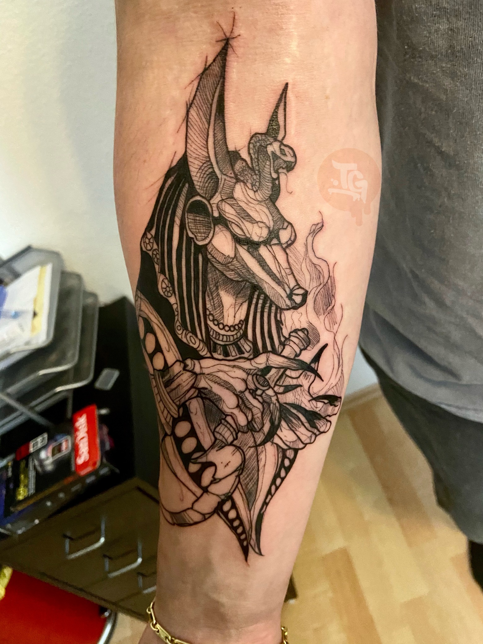 Blackwork Anubis forearm tattoo