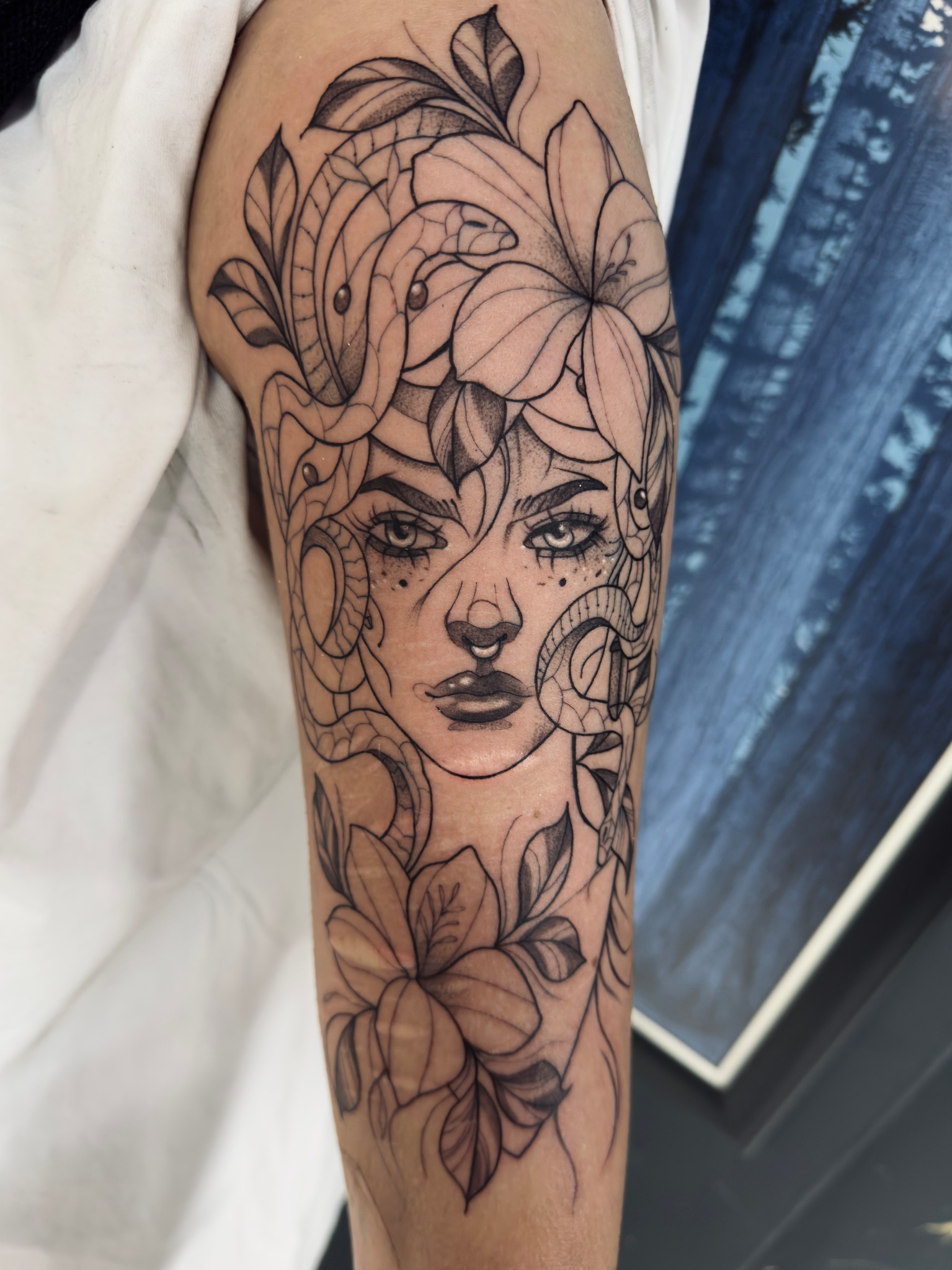 Illustrative woman and floral arm tattoo