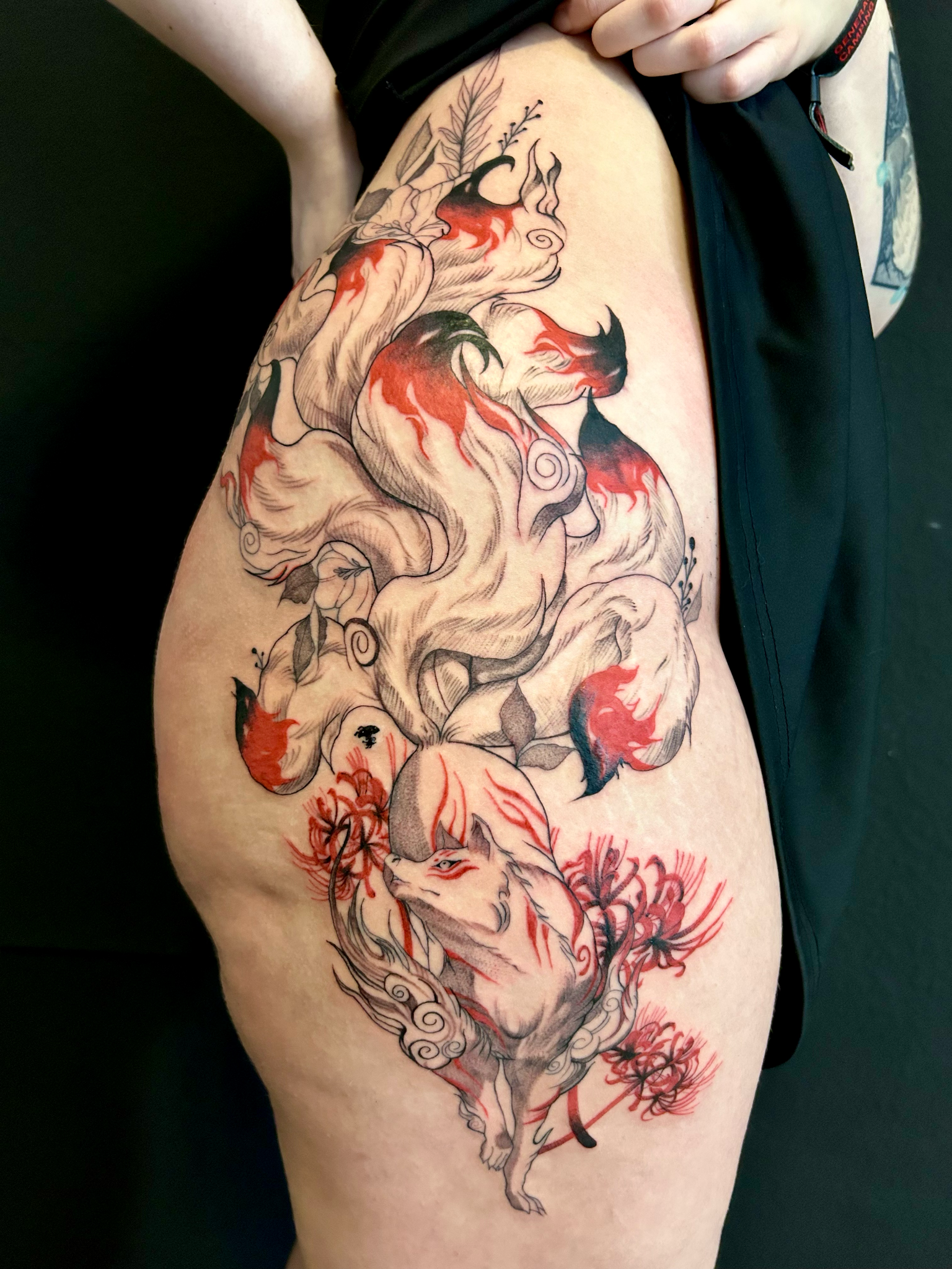 Red and black Japanese kitsune thigh tattoo