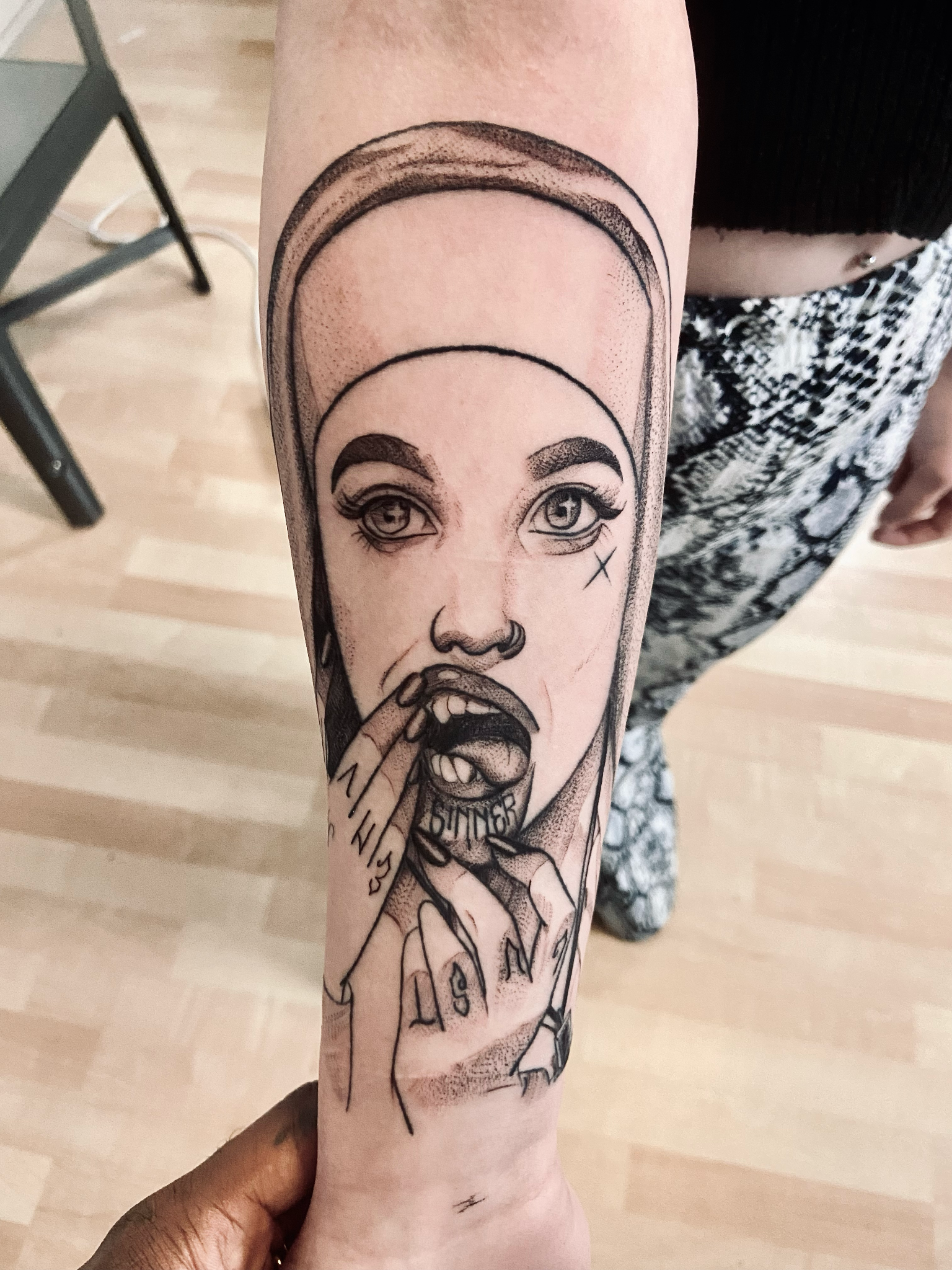 Illustrative black and grey portrait tattoo